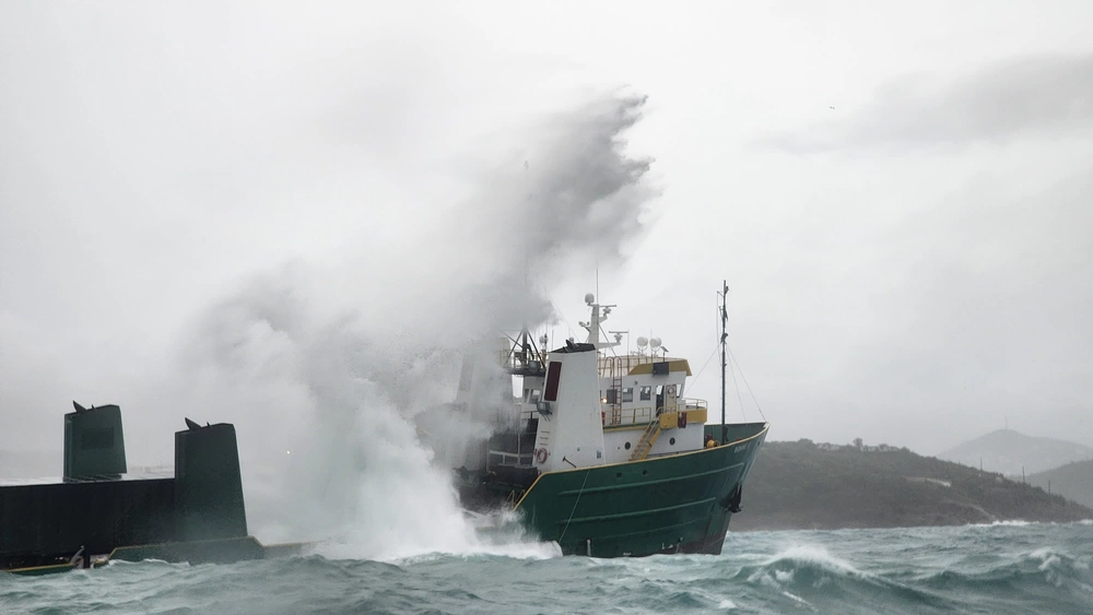 Coast Guard rescue crews assisted 12 people forced to abandon the 195-foot cargo vessel Bonnie G the morning of Oct. 4, 2023, after the vessel started taking on water and ran aground half a mile south from the local airport in St. Thomas.