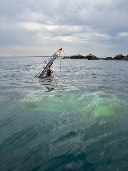 A sunken vessel observed just below the waterline.