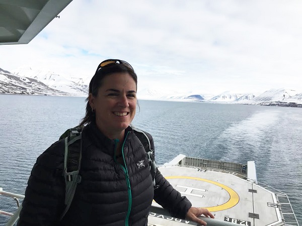 A profile photo of a woman with a watery arctic landscape in the background.