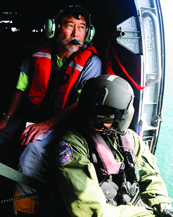 A man in a helicopter.