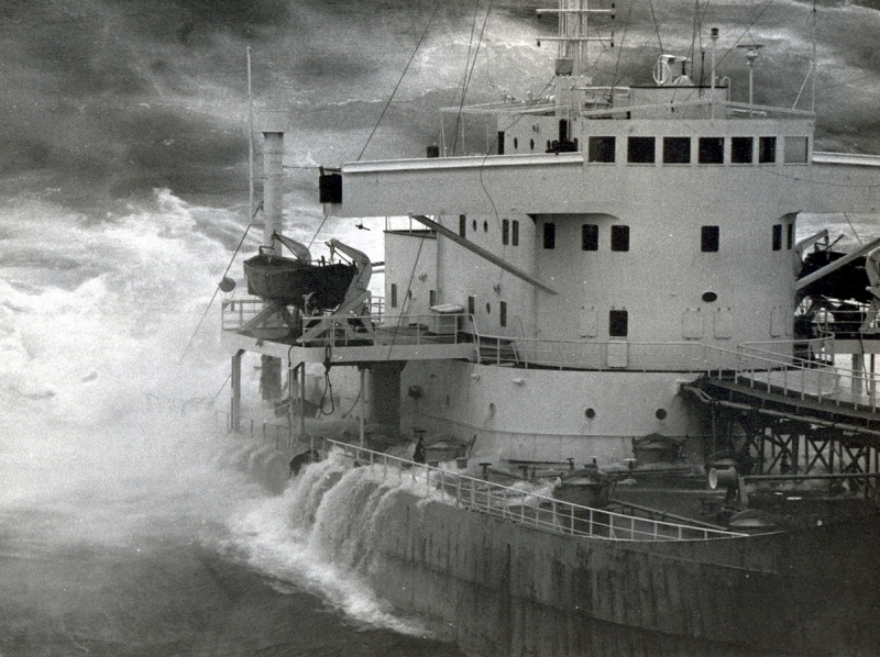 An old black and white photo of water covering the deck of a vessel.