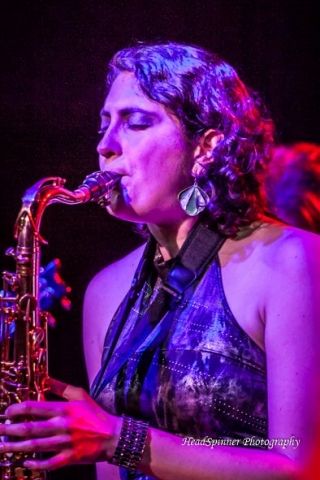 A woman playing a saxophone. 