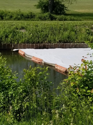Foam built up behind a pollution boom in a canal. 