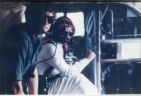 Two people on a helicopter.