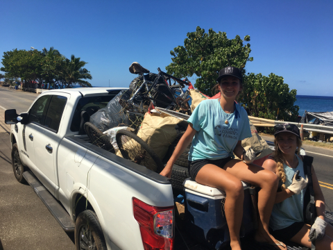 A person in a truck with debris in it.