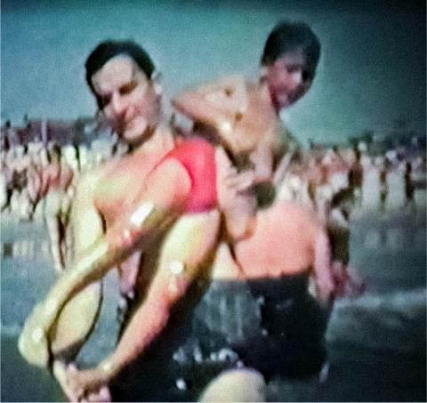 A man and a boy in the water.