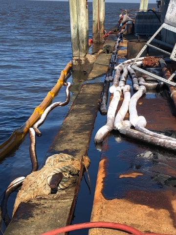 Oil on a platform and in water. 