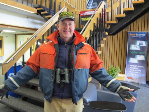 A man standing in front of a stairwell.
