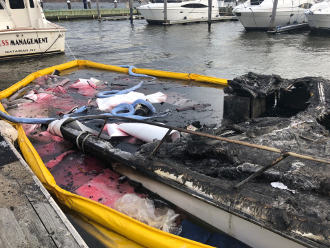 A sunken vessel with pollution boom around it.