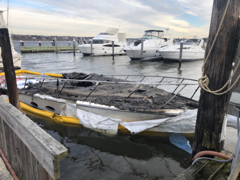 A sunken vessel with pollution boom around it.