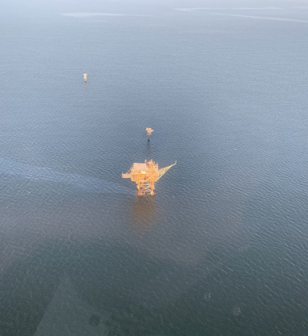 An aerial image of a sheen coming from an abandoned platform.