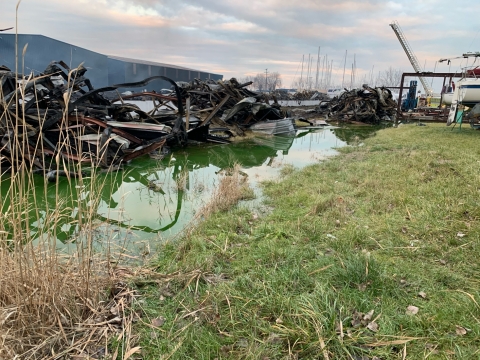 A ditch filled with green liquid. 