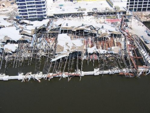 A destroyed building next to water.