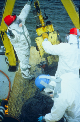 Workers in hazmat gear.