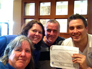 Four people pose for a photo. 