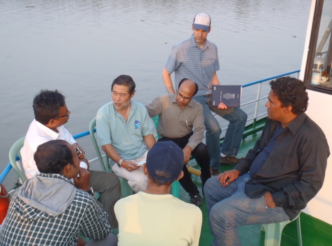 A group of people sitting on a boat.