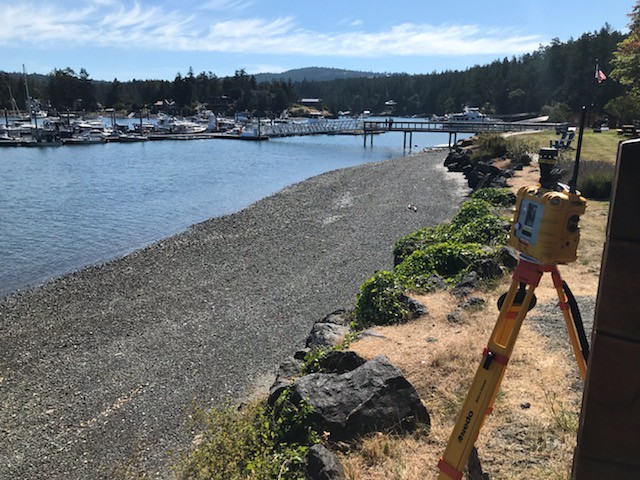 A device on a tripod on a shoreline.