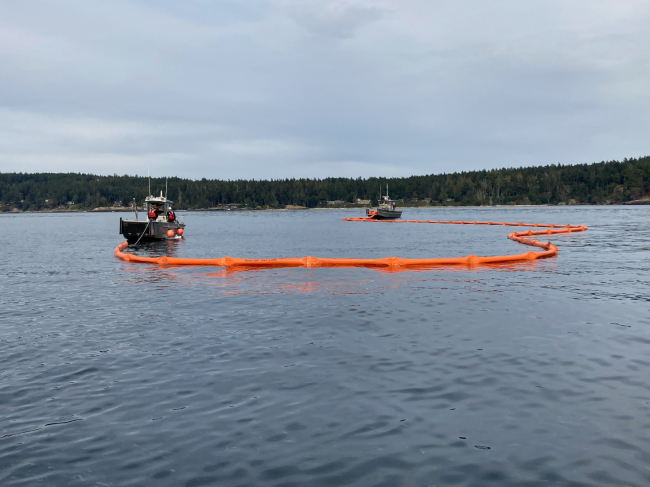 Vessels deploying pollution boom.
