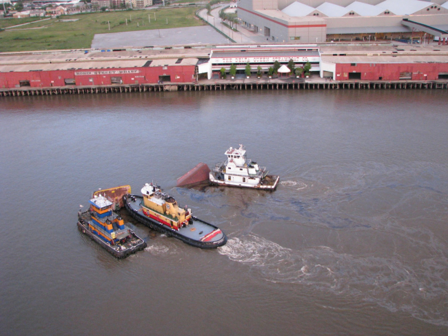 Three vessels on water with oil.