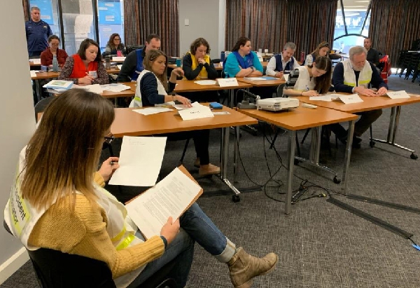 A group of people in a classroom setting.