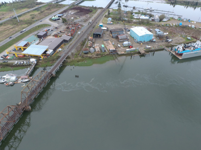 An aerial image of oil coming from a sinking vessel.
