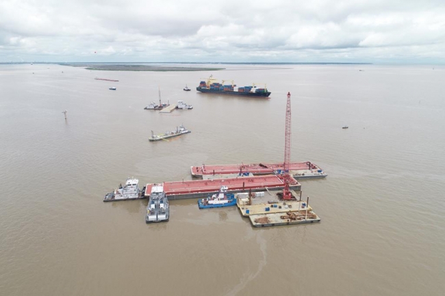 An aerial view of several larger vessels surrounded by smaller vessels. 