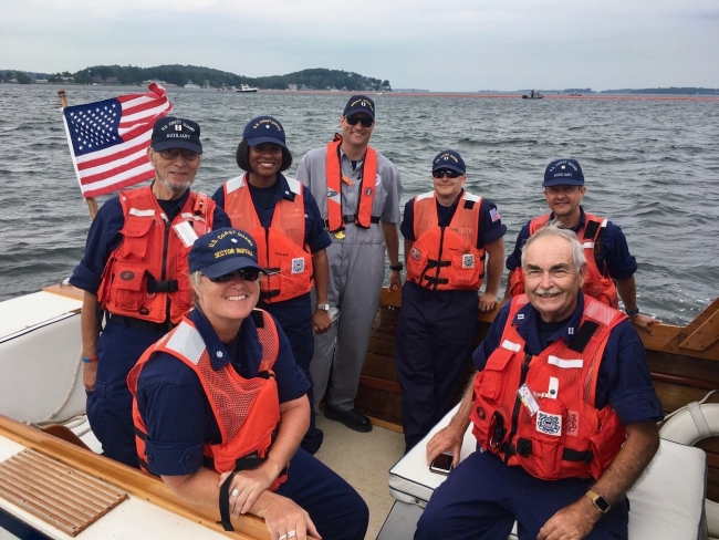 A group of people in life jackets on a boat.