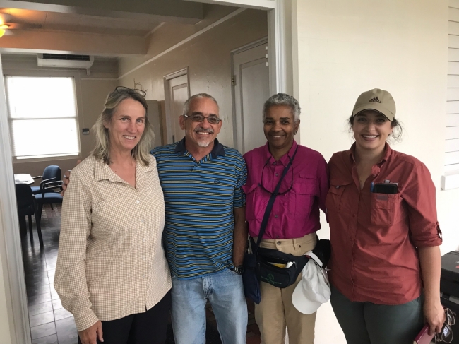 Four people pose for a photo.