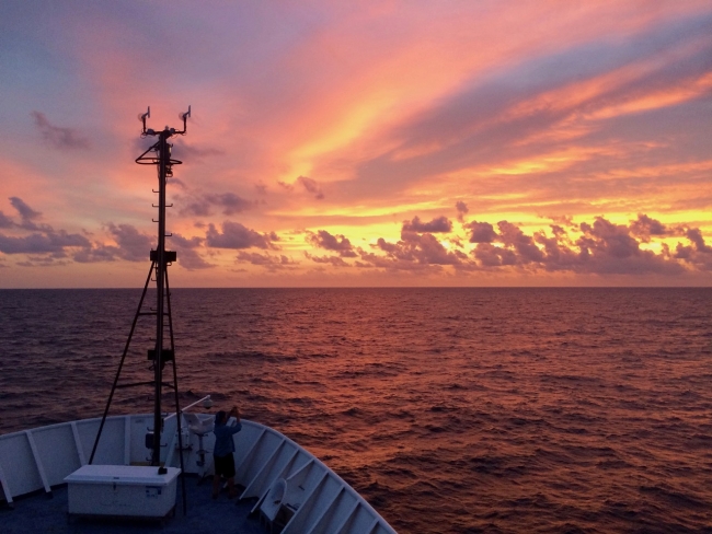 A sunset as seen from a vessel in water. 