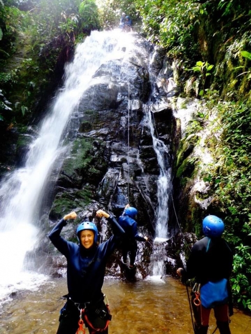 A group of people near a waterfall. 