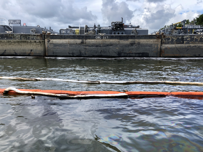 Pollution boom around a barge.