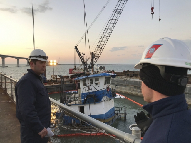 Two people in hard hats overseeing vessel operations. 
