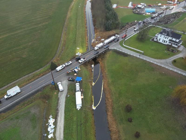 Booming and skimming operations to contain gasoline discharging to Hill Ditch.