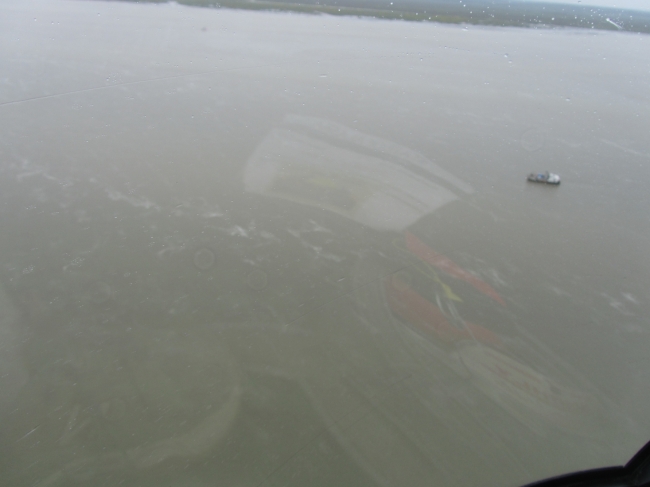 An aerial view of a sheen in water. 