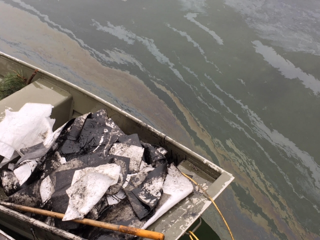 Oiled sorbent pads in dinghy.