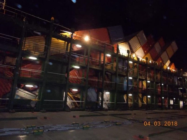 Rows of shipping containers leaning into one another. 
