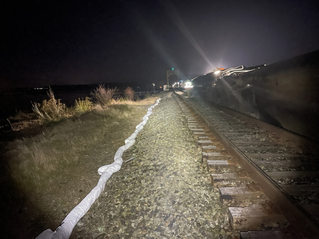 Sorbent boom around a derailed train.