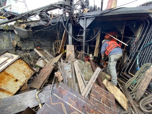 A person on a damaged boat.