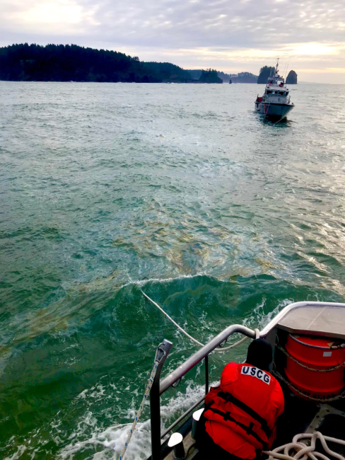 An oil sheen in water near a vessel.