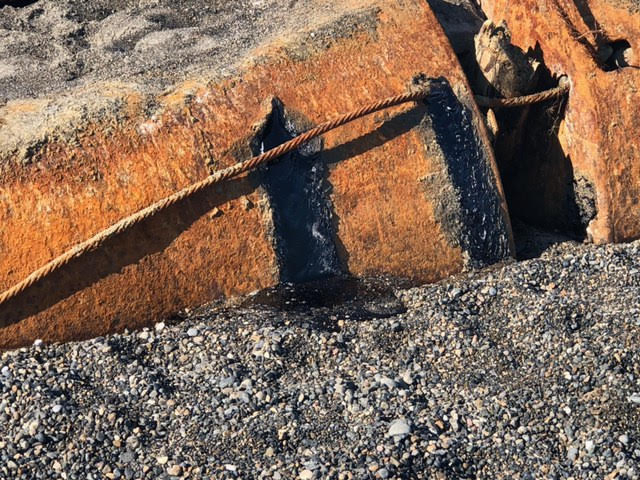Eroded tanks with tar leaking from them.