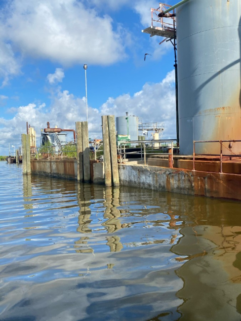 Pollution boom around an industrial storage area.