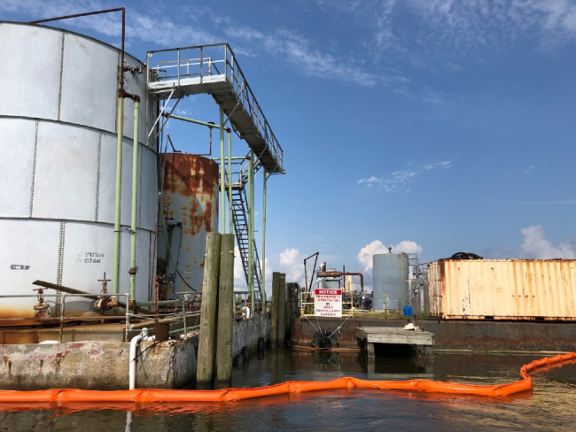 Pollution boom around an industrial storage area.