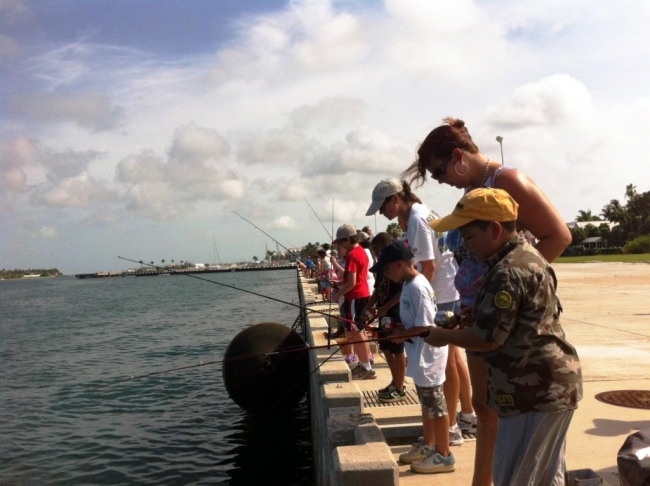 People fishing on a dock. 