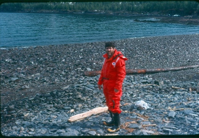 A person on a rocky beach.