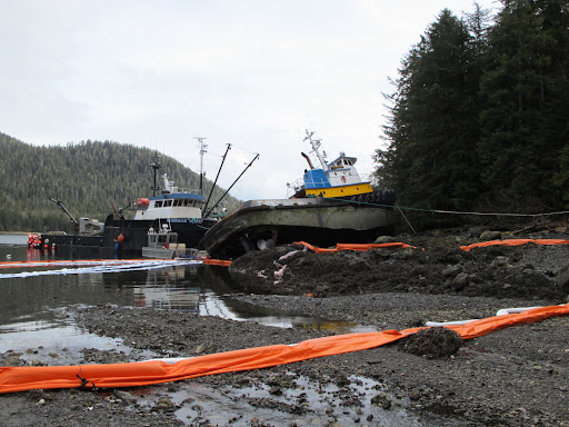 Pollution boom around a vessel.
