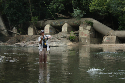 A fisherman in a river. 