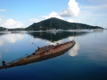 A derelict vessel that is almost completely submerged. 