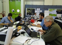 A group of people on computers at a table.