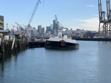A boat with a city skyline in the background. 