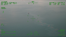 An aerial image of oil coming from a platform.